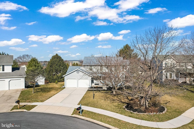 view of front facade featuring a residential view, an attached garage, concrete driveway, and a front yard