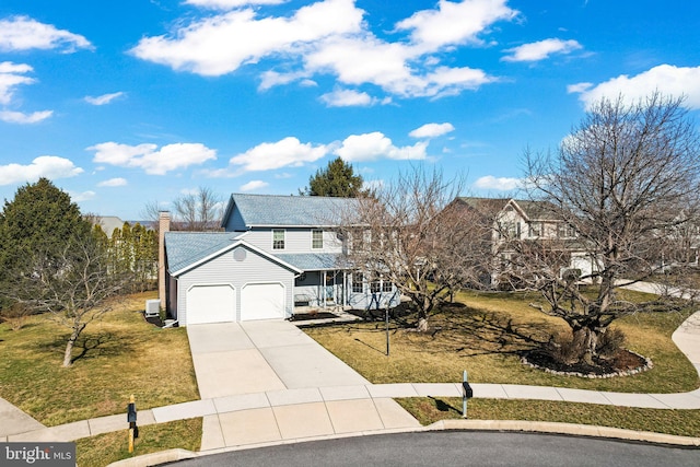 traditional home featuring a garage, covered porch, concrete driveway, and a front lawn