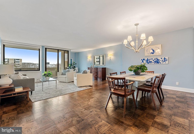 dining space with an inviting chandelier and baseboards