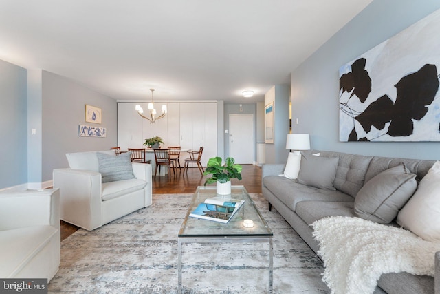 living room with wood finished floors and a notable chandelier