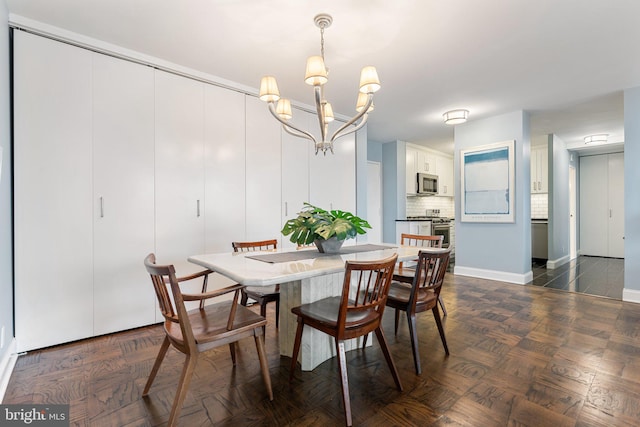 dining space with baseboards and an inviting chandelier