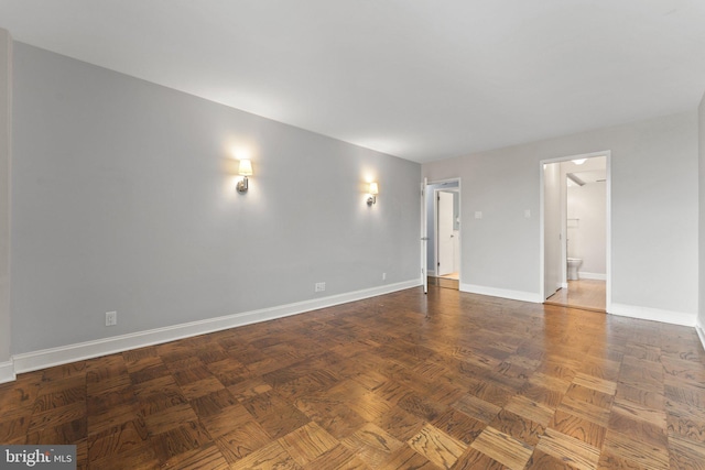 empty room featuring baseboards