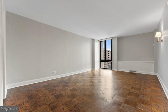 empty room featuring visible vents and baseboards