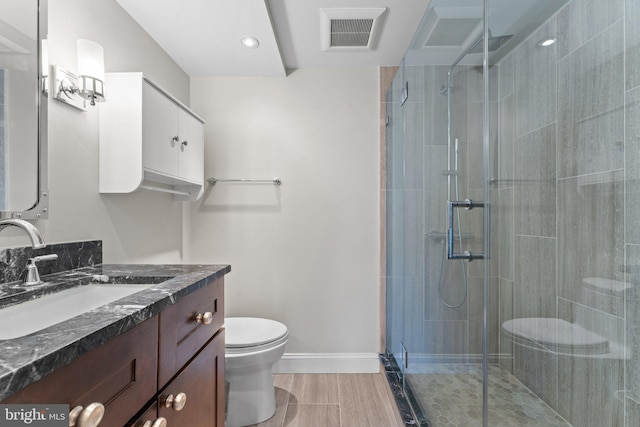 bathroom with baseboards, visible vents, a shower stall, and toilet