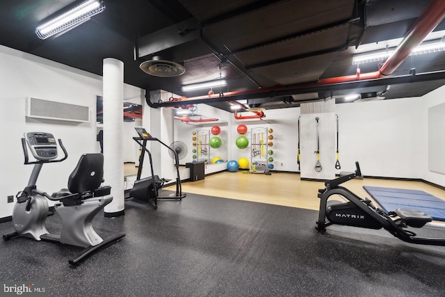 workout area featuring baseboards and visible vents