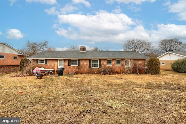 view of front of house with brick siding and a chimney