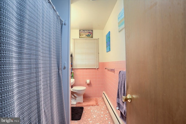 full bath featuring wainscoting, toilet, tile patterned floors, baseboard heating, and tile walls