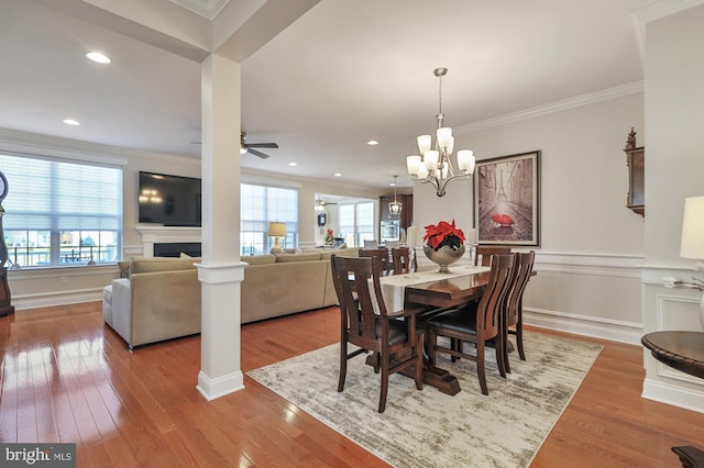 dining room featuring ornamental molding, a healthy amount of sunlight, and wood finished floors