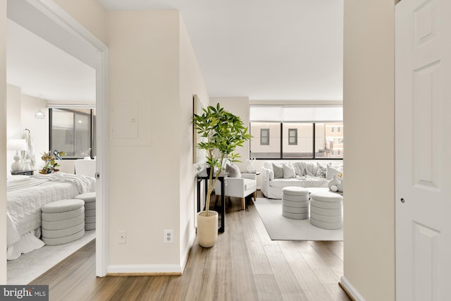 hall with wood finished floors and baseboards