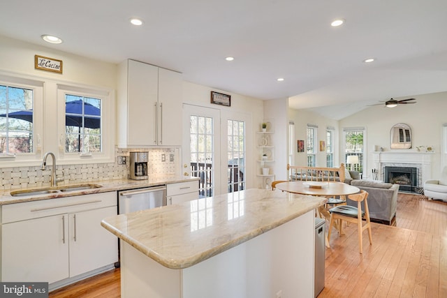 kitchen featuring plenty of natural light, a sink, and a center island