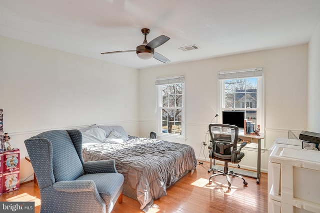 bedroom with visible vents, ceiling fan, and light wood-style flooring