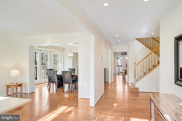 foyer entrance with crown molding, light wood finished floors, recessed lighting, stairway, and baseboards