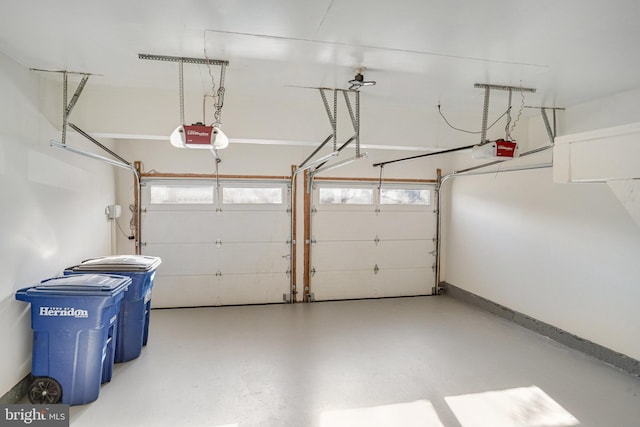 garage with baseboards and a garage door opener