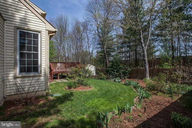 view of yard featuring fence and a wooden deck