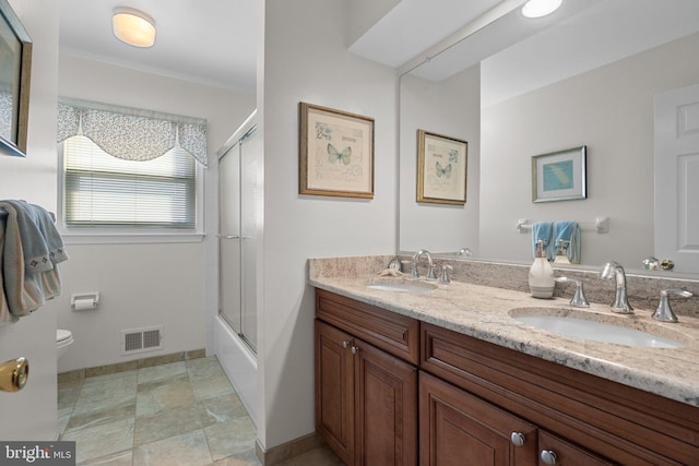 full bathroom featuring double vanity, toilet, visible vents, and a sink