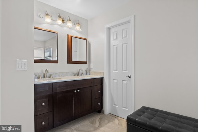 bathroom featuring a sink and double vanity