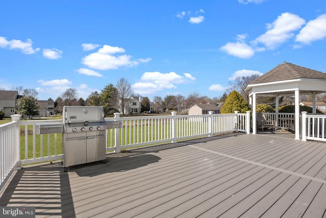 wooden terrace featuring a gazebo, a yard, a residential view, and grilling area