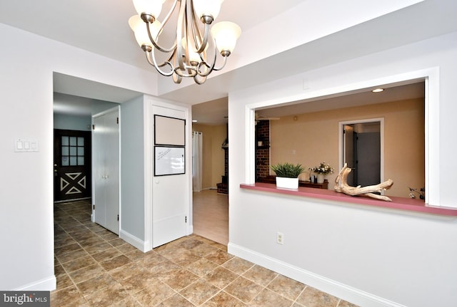 unfurnished dining area featuring an inviting chandelier and baseboards