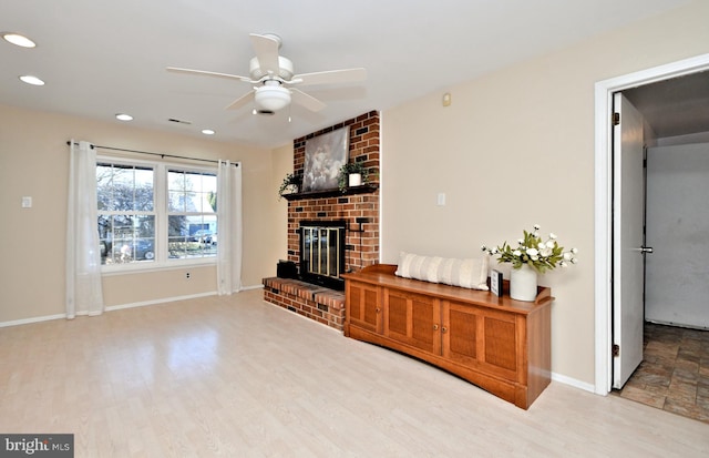 living room with ceiling fan, recessed lighting, wood finished floors, baseboards, and a brick fireplace