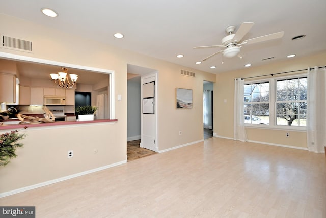 living area with light wood-type flooring, visible vents, and recessed lighting