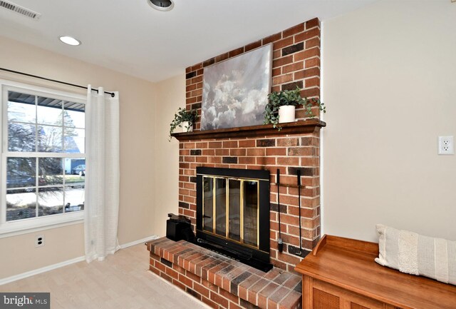 interior details with a fireplace, recessed lighting, visible vents, wood finished floors, and baseboards