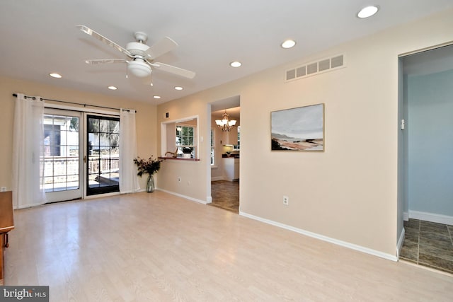 unfurnished room featuring baseboards, visible vents, and light wood-style floors