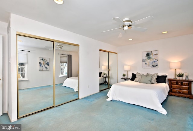 bedroom with recessed lighting, carpet flooring, ceiling fan, and two closets