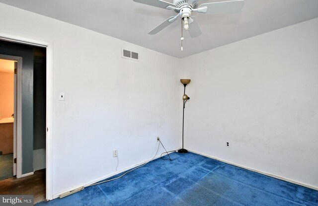 carpeted spare room with ceiling fan and visible vents