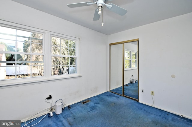 carpeted empty room featuring visible vents