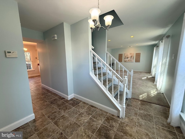 staircase with a chandelier, recessed lighting, and baseboards