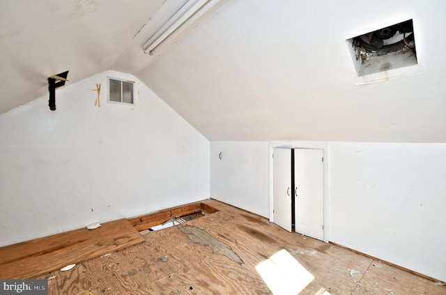 bonus room with lofted ceiling and visible vents