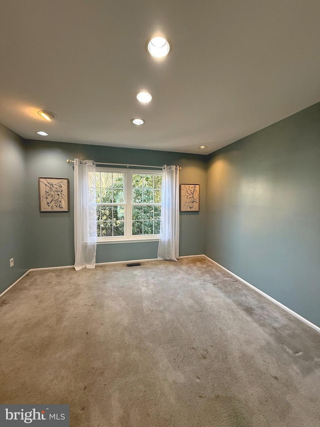 unfurnished room featuring carpet floors, recessed lighting, visible vents, and baseboards