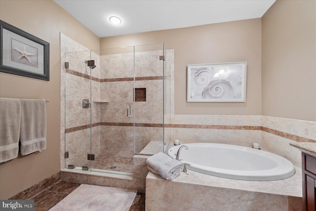 bathroom featuring a stall shower, a bath, vanity, and tile patterned flooring