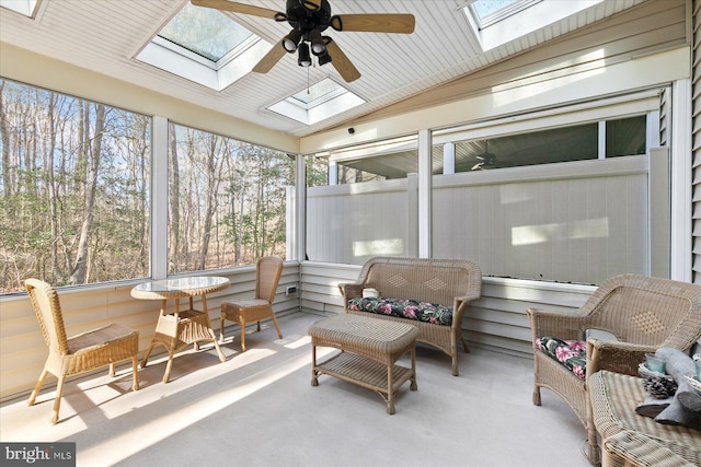 sunroom / solarium featuring lofted ceiling with skylight and ceiling fan