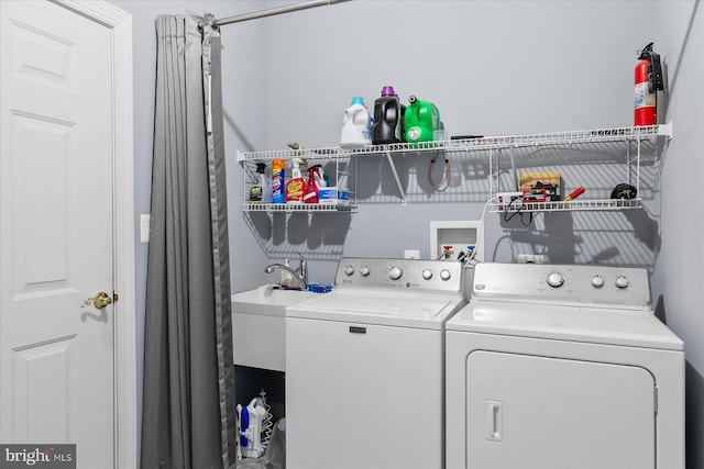 laundry room with independent washer and dryer