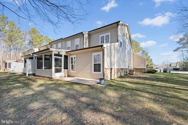 rear view of house with a patio area, a lawn, and a sunroom