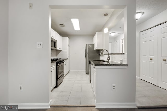 kitchen featuring light tile patterned floors, visible vents, appliances with stainless steel finishes, white cabinetry, and a sink