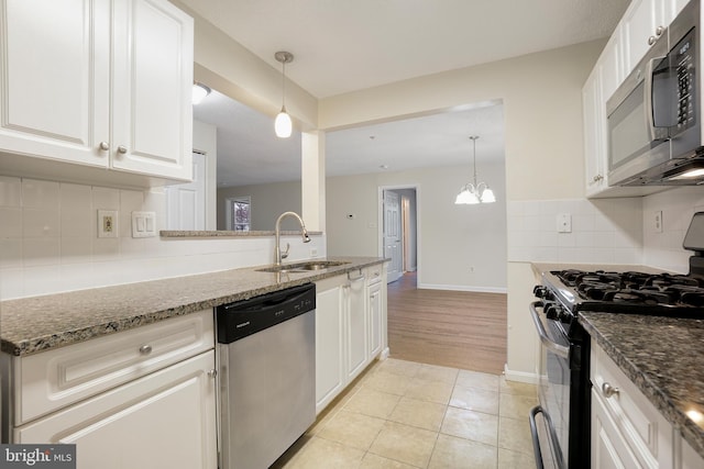 kitchen featuring light tile patterned floors, backsplash, appliances with stainless steel finishes, white cabinetry, and a sink