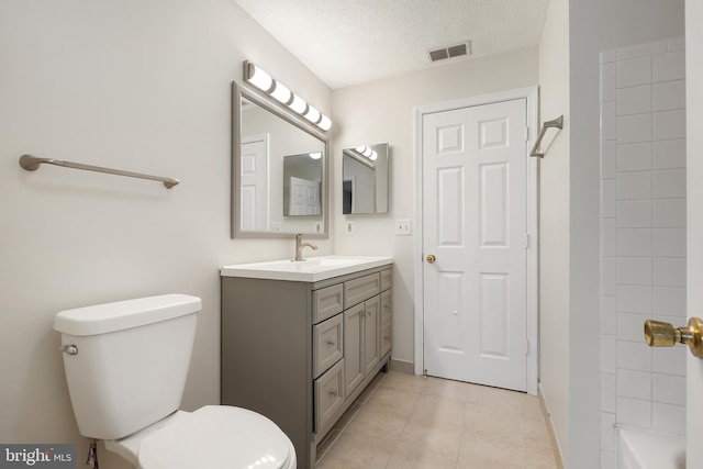 bathroom featuring a textured ceiling, toilet, vanity, visible vents, and tile patterned floors