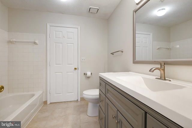 full bathroom with tile patterned flooring, a textured ceiling, toilet, and vanity