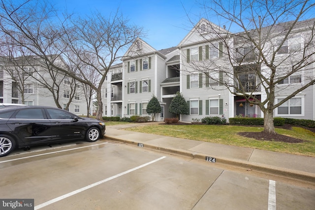 view of property featuring uncovered parking