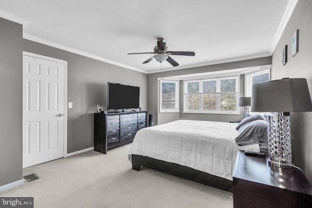 carpeted bedroom with visible vents, baseboards, and ornamental molding