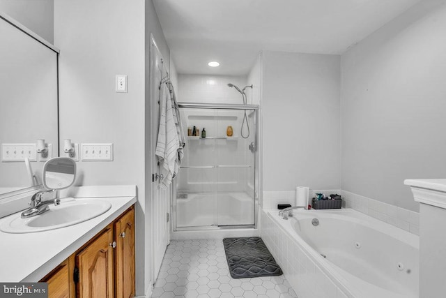 bathroom featuring tile patterned floors, a tub with jets, a stall shower, and vanity