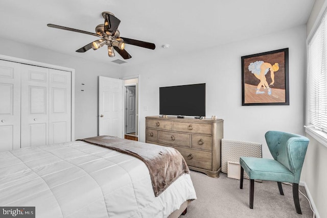 bedroom with visible vents, a closet, carpet floors, and ceiling fan