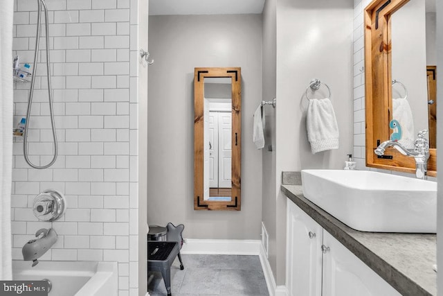 full bath featuring baseboards, tile patterned flooring, vanity, and  shower combination