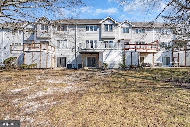 back of house featuring a lawn and central AC unit