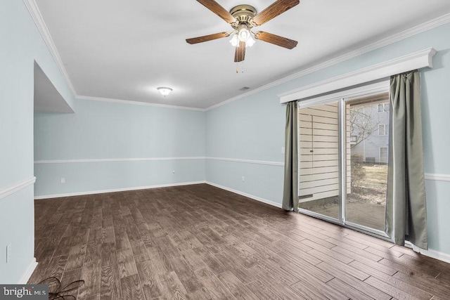 unfurnished room featuring crown molding, baseboards, and wood finished floors