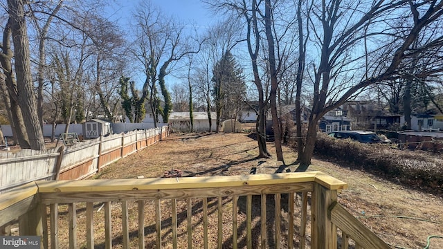 view of yard featuring a fenced backyard, a residential view, an outbuilding, and a shed