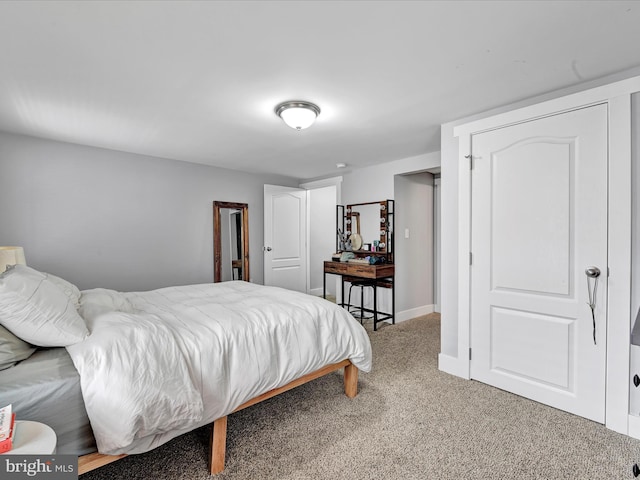 carpeted bedroom featuring baseboards