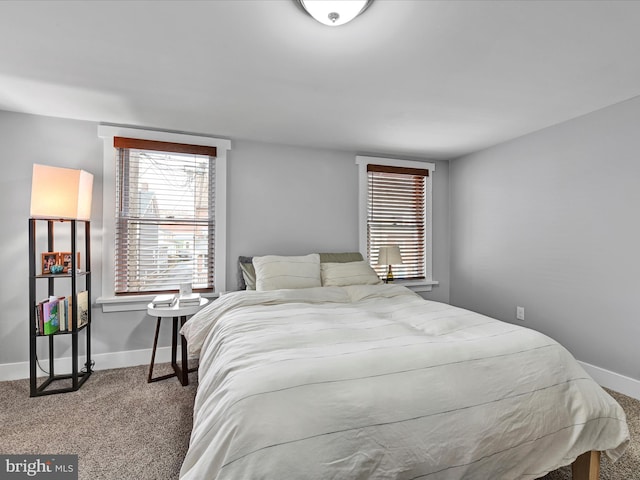 carpeted bedroom with baseboards